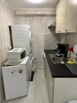 a small kitchen with a microwave and a sink at Rumen Apartment in Nesebar