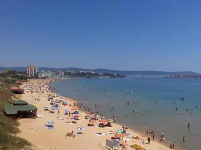 a group of people on a beach in the water at Rumen Apartment in Nesebar