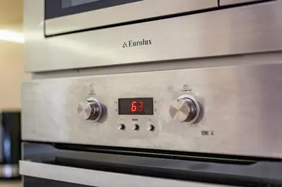 an oven with a digital clock on it at Top Location 3 Bedroom Apartment Next to the Beach in Varna City