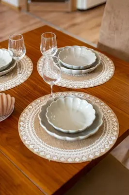 a table with white plates and wine glasses on it at Top Location 3 Bedroom Apartment Next to the Beach in Varna City