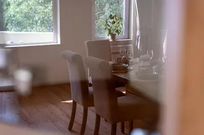 a dining room table and chairs with a table and window at Top Location 3 Bedroom Apartment Next to the Beach in Varna City