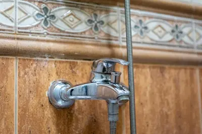 a faucet in a bathroom with a shower at Top Location 3 Bedroom Apartment Next to the Beach in Varna City