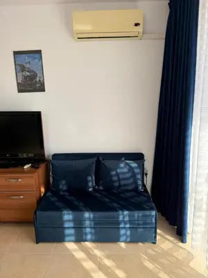 a bed in a room with a tv and a couch at BW - Happy 67 in Sunny Beach