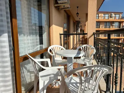 a patio with a table and chairs on a balcony at BW - Happy 67 in Sunny Beach
