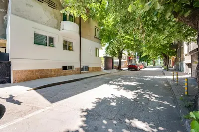 an empty street with trees and a building at Top Central Flats with Style in Varna City