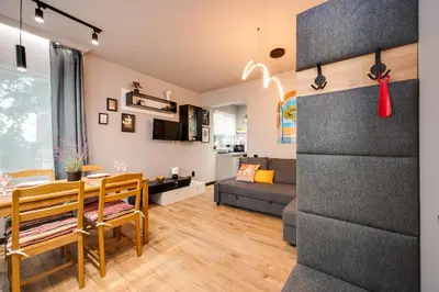 a living room with a table and a dining room at Top Central Flats with Style in Varna City