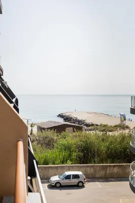 a car parked in a parking lot next to a beach at Marea 1 in Pomorie