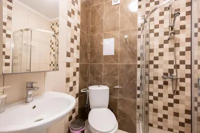 a bathroom with a toilet and a sink and a shower at Marea 1 in Pomorie