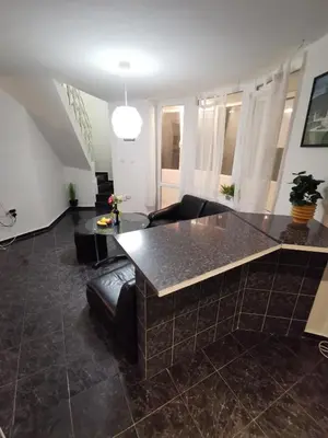 a living room with a table and a couch at Мезонет в Гръцката Махала in Varna City