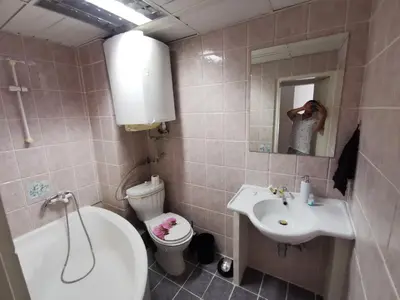a person taking a picture of a bathroom at Мезонет в Гръцката Махала in Varna City