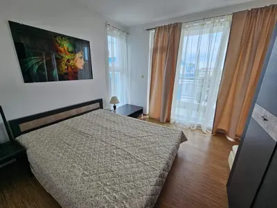 a bedroom with a bed and a large window at Odisei Large Studio in Nesebar