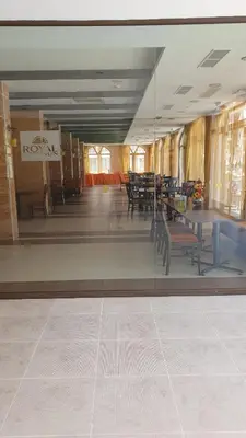 a room with tables and chairs in a building at Royal Sun Apartment in Sunny Beach