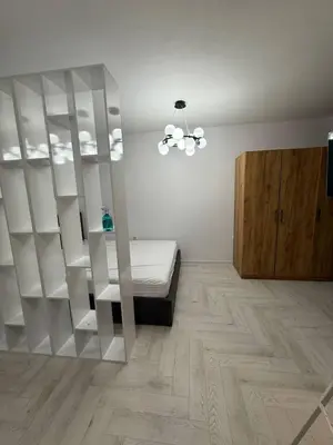 a bedroom with white shelves and a bed in a room at Sveti Vlas, Rodopi Bay Residence in Sveti Vlas