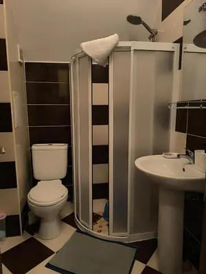 a bathroom with a toilet and a sink at Golden Hermes, Studio z basenem in Sunny Beach