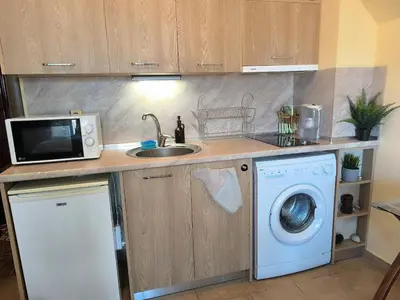 a kitchen with a sink and a washing machine at Golden Hermes, Studio z basenem in Sunny Beach