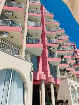 an apartment building with red balconies on the side at Rose Garden Apartment 10 in Sunny Beach
