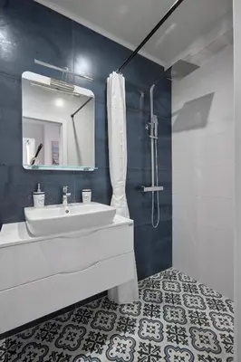 a bathroom with a white sink and a mirror at SEA SHELL Apartment in Sozopol