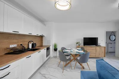 a kitchen and dining room with a table and chairs at SEA SHELL Apartment in Sozopol