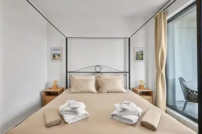 a bedroom with a large bed with towels on it at SEA SHELL Apartment in Sozopol