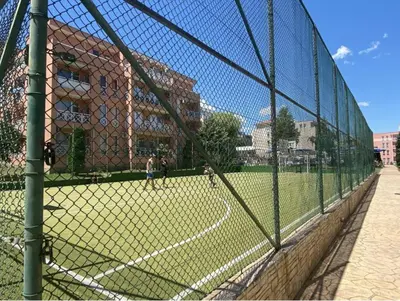 a chain link fence with people on a baseball field at Sunny Day 6 Studio 11 in Sunny Beach