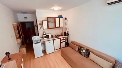 a small living room with a couch and a refrigerator at Sunny Day 6 Studio 11 in Sunny Beach