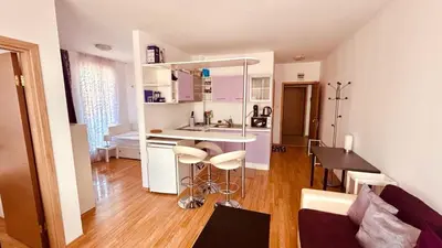 a kitchen and living room with a counter and a table at SUNNY DAY 6, Apartment 35 in Sunny Beach