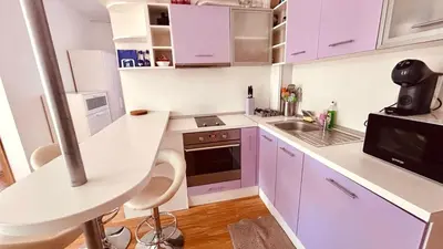a white kitchen with purple cabinets and a sink at SUNNY DAY 6, Apartment 35 in Sunny Beach