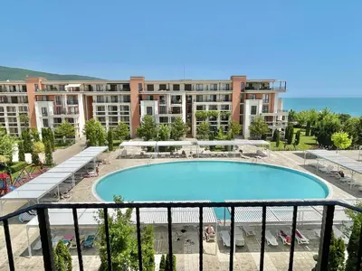 a large swimming pool in front of a large building at Prestige Fort Aparthotel - Private apartment - BSR - 3 in Sveti Vlas