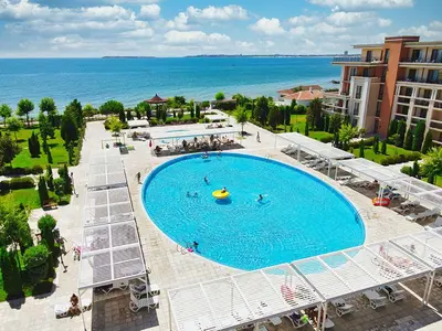 an overhead view of a large swimming pool next to the ocean at Prestige Fort Aparthotel - Private apartment - BSR - 3 in Sveti Vlas