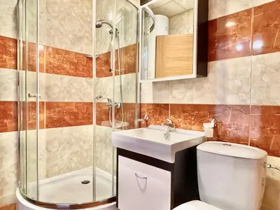 a bathroom with a shower and a toilet and a sink at Prestige Fort Aparthotel - Private apartment - BSR - 3 in Sveti Vlas