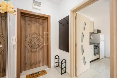 a room with a wooden door and a kitchen at Marea 2 in Pomorie