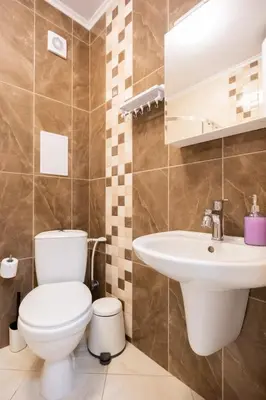 a bathroom with a toilet and a sink at Marea 2 in Pomorie