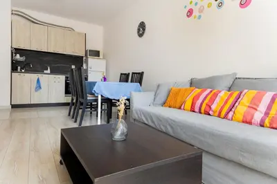 a living room with a couch and a table at Marea 2 in Pomorie