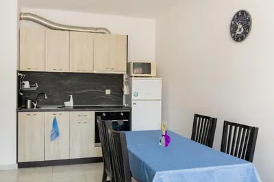 a kitchen with a table with a blue table cloth at Marea 2 in Pomorie