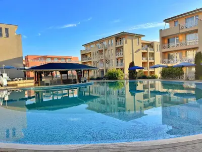 a large swimming pool in front of some buildings at Chocolate Apartment on Sunny Day 6 Complex in Tŭnkovo