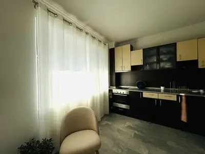 a small kitchen with a chair and a window at AQUA BLUE APARTMENTS 38 Penthouse Sunny Beach in Sunny Beach
