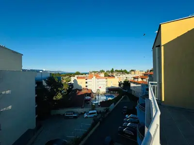 a view of a city with cars parked in a parking lot at AQUA BLUE APARTMENTS 38 Penthouse Sunny Beach in Sunny Beach