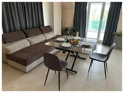 a living room with a couch and a table and chairs at Top floor luxury apartment in Sunny Beach in Sunny Beach