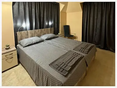 a bedroom with a large bed with black curtains at Top floor luxury apartment in Sunny Beach in Sunny Beach