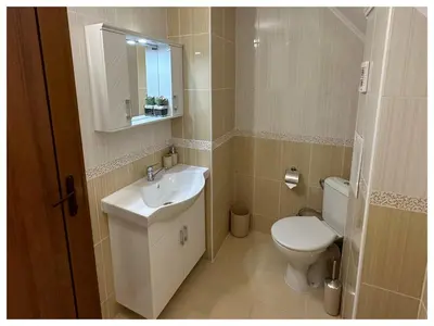 a bathroom with a sink and a toilet and a mirror at Top floor luxury apartment in Sunny Beach in Sunny Beach