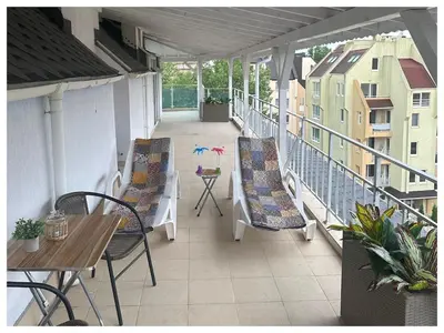 a balcony with chairs and a table on a building at Top floor luxury apartment in Sunny Beach in Sunny Beach