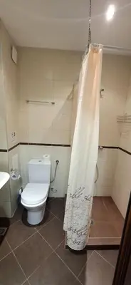 a bathroom with a toilet and a shower curtain at Byala Vista A-54 in Byala