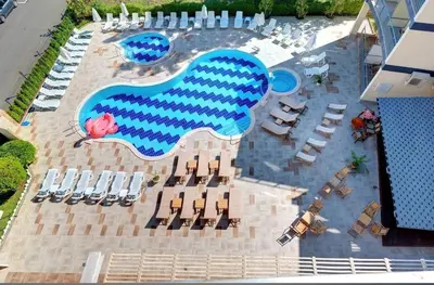 an overhead view of a swimming pool with chairs and tables at Hotel Solemar in Sunny Beach