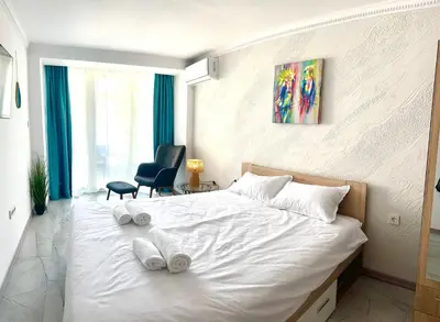 a bedroom with a white bed with towels on it at Hotel Solemar in Sunny Beach