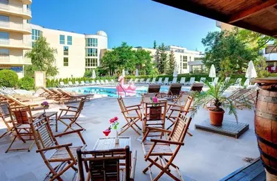 a patio with chairs and tables and a pool at Hotel Solemar in Sunny Beach