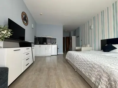 a bedroom with a white bed and a tv at BW - Studio Grenada 316B in Sunny Beach