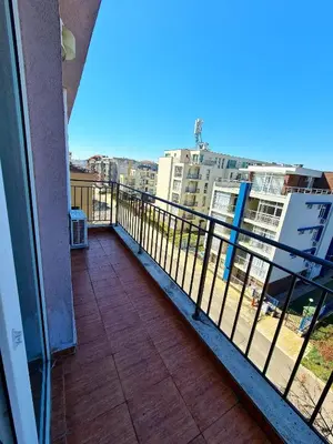 a balcony with a view of a city with buildings at Тристаен просторен апартамент с две отделни спални in Sunny Beach