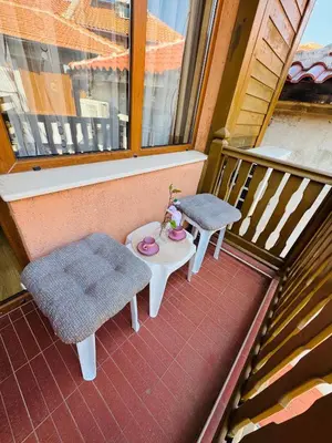 a balcony with two chairs and a table on a balcony at Guest House Amfora with a sea view in Sozopol