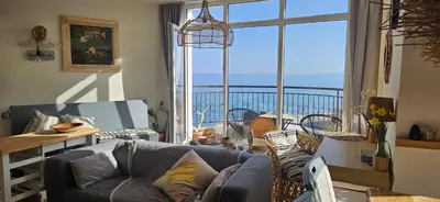 a living room with a couch and a view of the ocean at Boho Breeze Aheloy in Aheloy