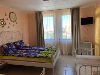 a childs bedroom with a crib and a window at Apartment Terrace under the stars in Primorsko
